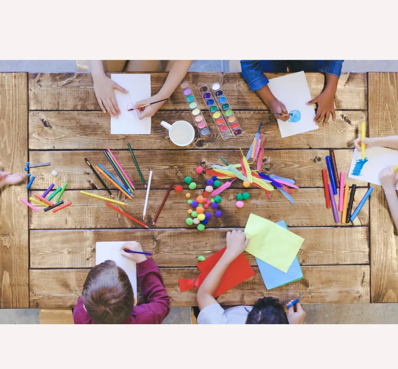 bird's eye view of kids at a craft table